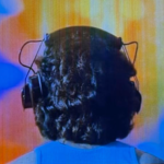 Screenshot from the Made for TV Movie The Boy in the Plastic Bubble that shows Todd listening to music and watching a light show.