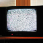 Image depicts an older telvision set with snow.